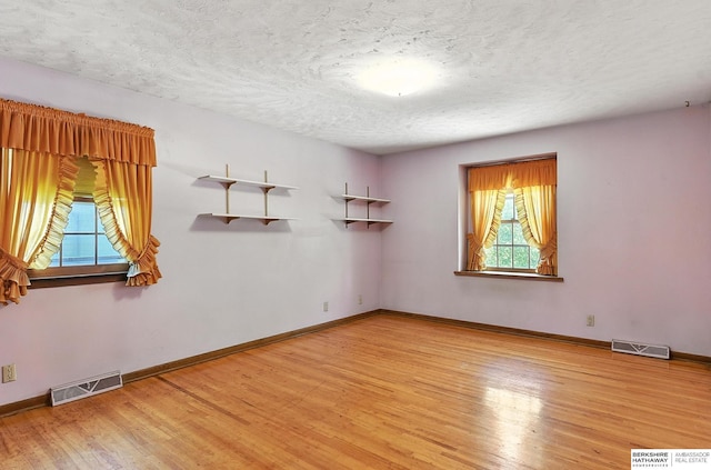 3629 S 114th Ave, Omaha, NE 68144 - spare room featuring wood finished floors and a textured ceiling