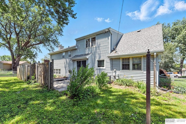 3629 S 114th Ave, Omaha, NE 68144 - back of property with a shingled roof and a chimney