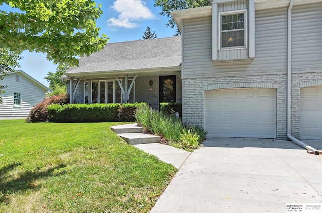 3629 S 114th Ave, Omaha, NE 68144 - view of front of home with a front yard, a garage, driveway, and brick siding