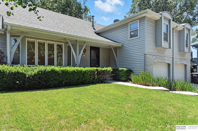 3629 S 114th Ave, Omaha, NE 68144 - view of front of house featuring brick siding, a front yard, a garage, and roof with shingles