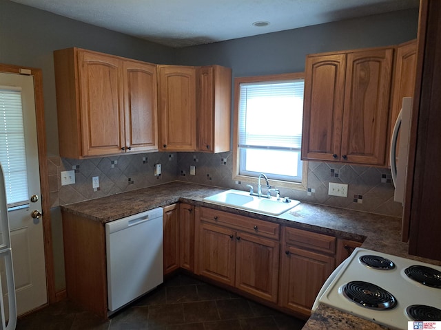 1519 Washington St, Lincoln, NE 68502 - kitchen featuring white appliances, a sink, tasteful backsplash, and dark tile patterned flooring