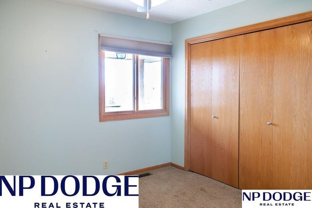 611 Diamond Ln, Papillion, NE 68133 - unfurnished bedroom featuring carpet floors, a closet, and baseboards