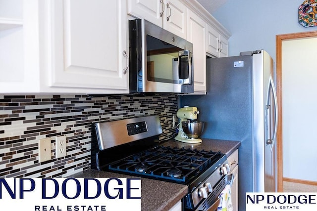 611 Diamond Ln, Papillion, NE 68133 - kitchen featuring stainless steel appliances, dark countertops, backsplash, and white cabinetry