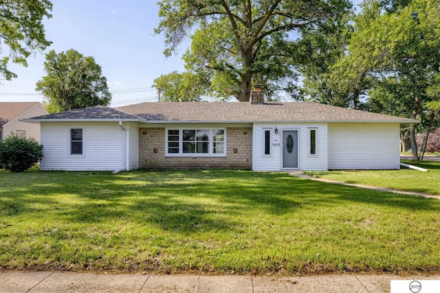 1801 Elk St, Beatrice, NE 68310 - single story home featuring a front yard, a chimney, stone siding, and a shingled roof