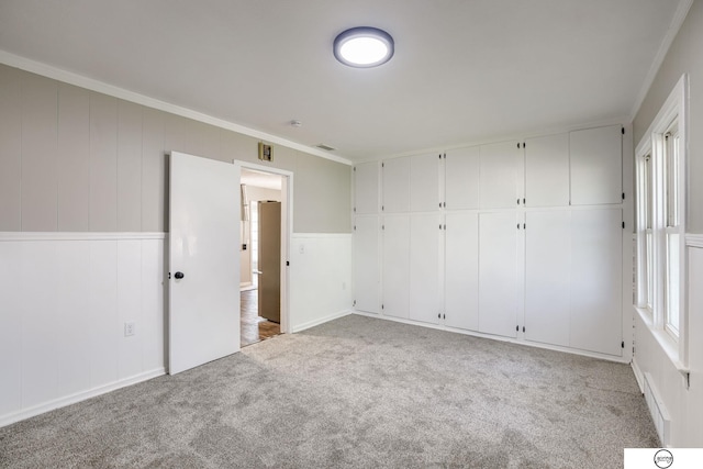 1801 Elk St, Beatrice, NE 68310 - unfurnished bedroom featuring light carpet and crown molding