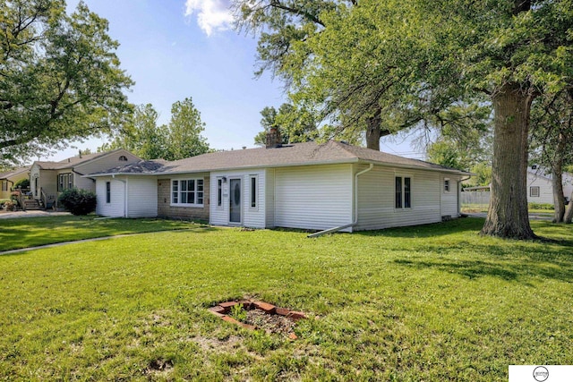 1801 Elk St, Beatrice, NE 68310 - ranch-style house featuring a front yard and a chimney
