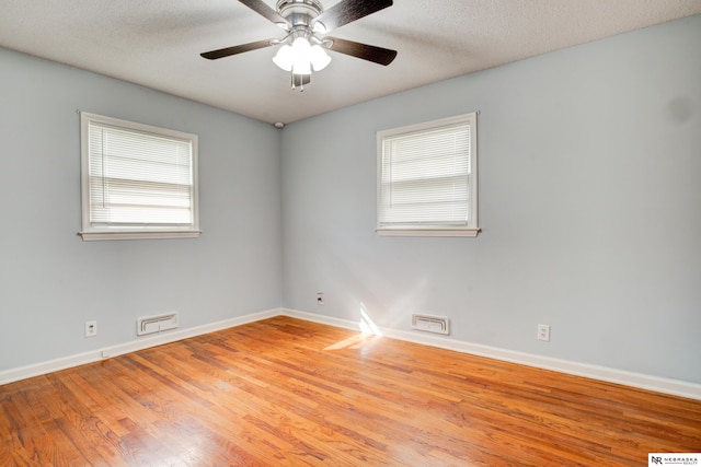 6205 Nebraska Ave, Omaha, NE 68104 - unfurnished room featuring wood finished floors, baseboards, a ceiling fan, and a textured ceiling