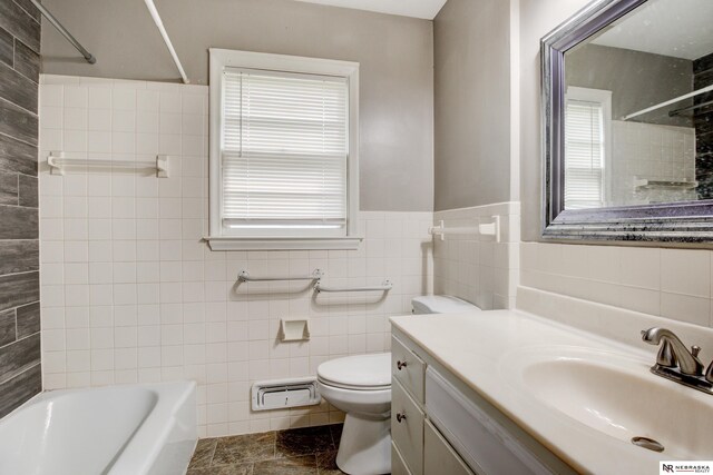 6205 Nebraska Ave, Omaha, NE 68104 - bathroom featuring tile walls, vanity, toilet,  shower combination, and a wainscoted wall
