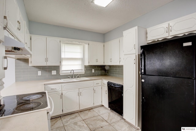 6205 Nebraska Ave, Omaha, NE 68104 - kitchen with black appliances, a sink, tasteful backsplash, white cabinets, and light countertops