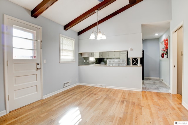 6205 Nebraska Ave, Omaha, NE 68104 - foyer entrance with a chandelier, light wood-style floors, and baseboards