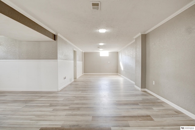 6205 Nebraska Ave, Omaha, NE 68104 - unfurnished room featuring a textured wall, ornamental molding, wood finished floors, a textured ceiling, and baseboards