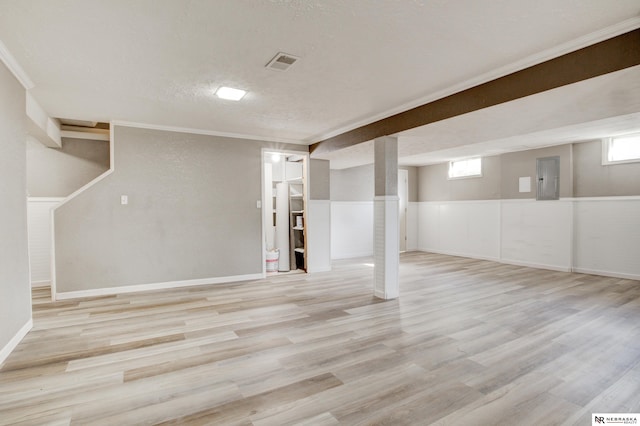 6205 Nebraska Ave, Omaha, NE 68104 - below grade area with wood finished floors, electric panel, crown molding, healthy amount of natural light, and a textured ceiling