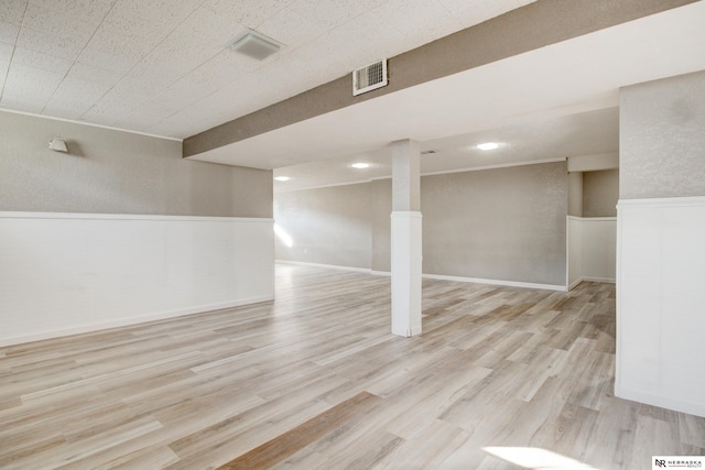 6205 Nebraska Ave, Omaha, NE 68104 - finished basement featuring a wainscoted wall and light wood-style floors