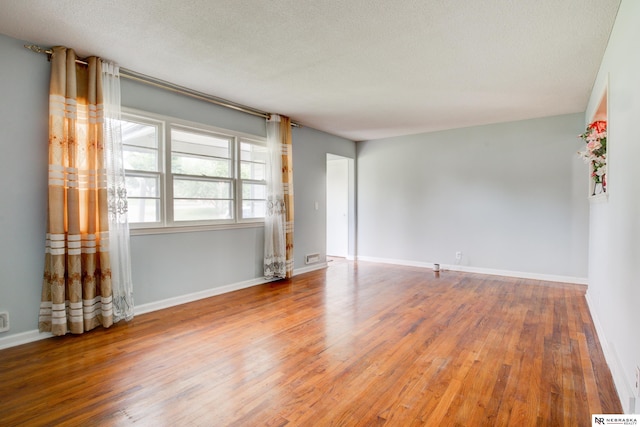 6205 Nebraska Ave, Omaha, NE 68104 - empty room with wood finished floors, baseboards, and a textured ceiling