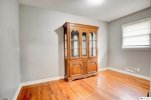 6205 Nebraska Ave, Omaha, NE 68104 - unfurnished room with light wood-type flooring, baseboards, and a textured ceiling