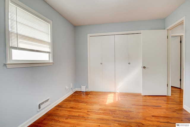 6205 Nebraska Ave, Omaha, NE 68104 - unfurnished bedroom featuring light wood-style floors, a closet, and baseboards