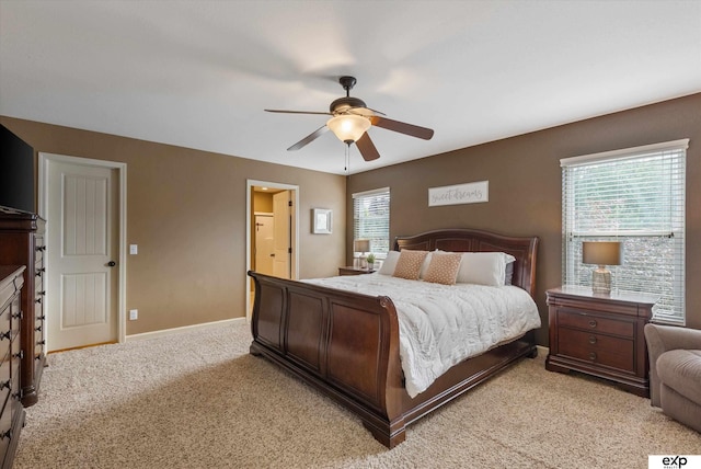 8815 N Hws Cleveland Blvd, Bennington, NE 68007 - bedroom featuring light carpet, baseboards, a ceiling fan, and ensuite bath