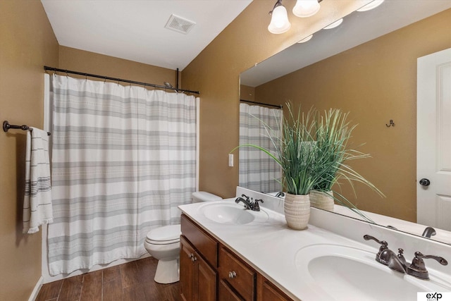 8815 N Hws Cleveland Blvd, Bennington, NE 68007 - bathroom with toilet, double vanity, wood finished floors, and a shower with shower curtain