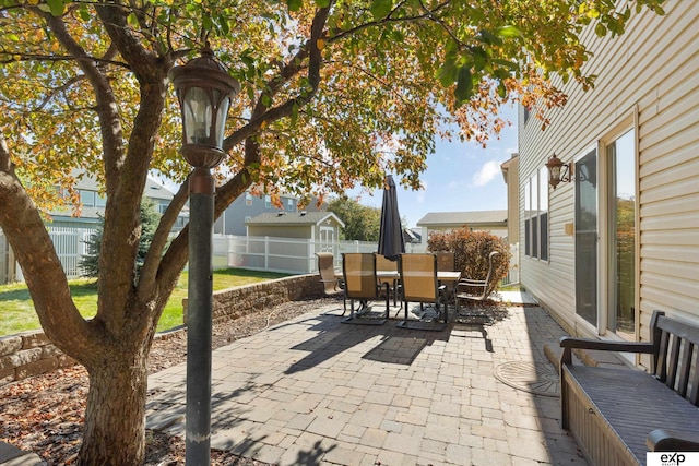 8815 N Hws Cleveland Blvd, Bennington, NE 68007 - fenced backyard featuring a patio, outdoor dining space, and an outbuilding