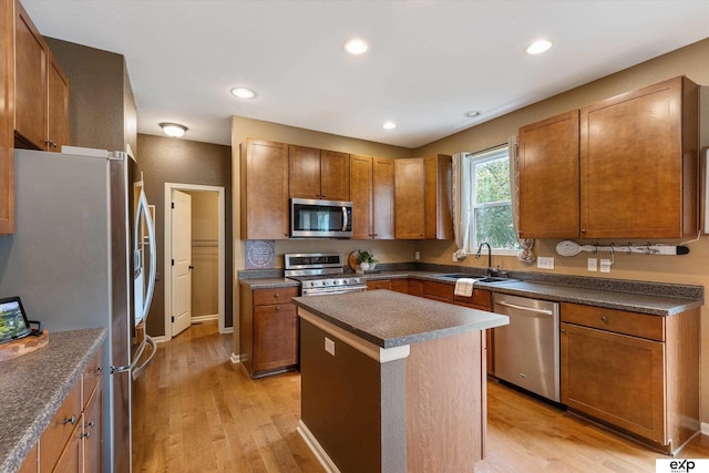 8815 N Hws Cleveland Blvd, Bennington, NE 68007 - kitchen featuring appliances with stainless steel finishes, a sink, dark countertops, light wood finished floors, and recessed lighting