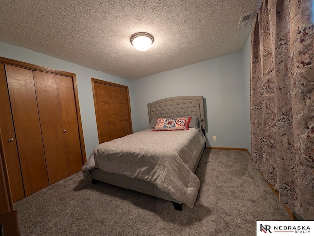 2496 Rock Creek Rd, Bee, NE 68314 - carpeted bedroom with two closets and a textured ceiling