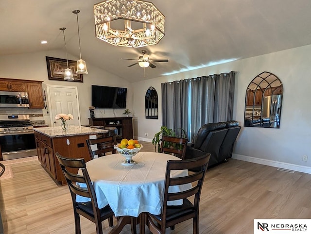 2496 Rock Creek Rd, Bee, NE 68314 - dining area featuring a ceiling fan, light wood finished floors, vaulted ceiling, baseboards, and a chandelier