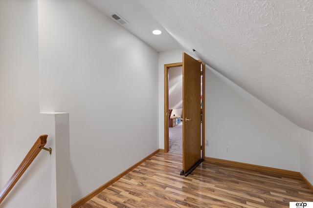 17205 Jessica Ln, Gretna, NE 68028 - additional living space with a textured ceiling, vaulted ceiling, and light wood finished floors