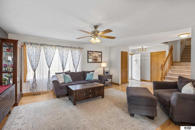 17205 Jessica Ln, Gretna, NE 68028 - living area featuring stairway, ceiling fan, and light wood-style flooring