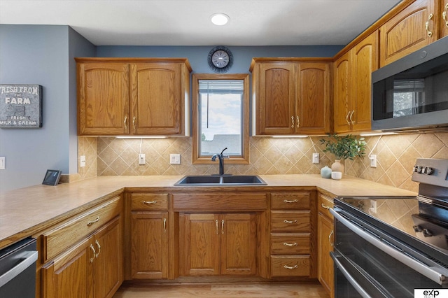17205 Jessica Ln, Gretna, NE 68028 - kitchen featuring range with two ovens, light countertops, brown cabinetry, and recessed lighting