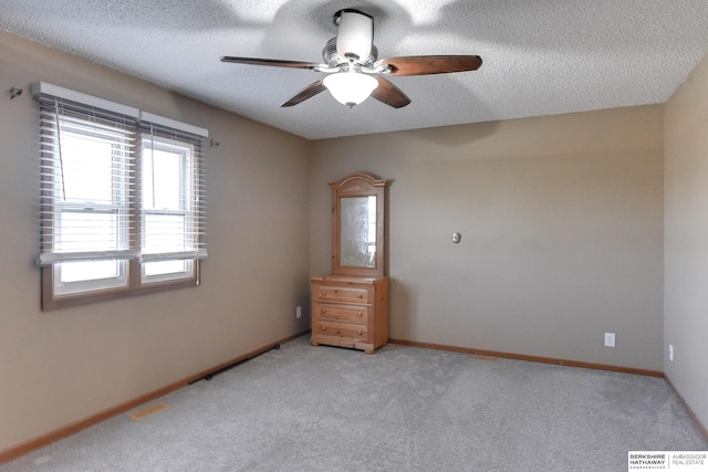 3027 S 144th Ave, Omaha, NE 68144 - empty room featuring a ceiling fan, light carpet, a textured ceiling, and baseboards