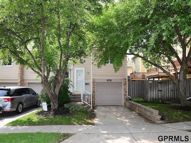 3821 Davenport St, Omaha, NE 68131 - view of property with a garage, concrete driveway, and brick siding