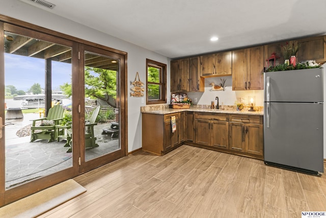 2250 Pathfinder Dr, Fremont, NE 68025 - kitchen featuring freestanding refrigerator, light wood finished floors, recessed lighting, baseboards, and a sink