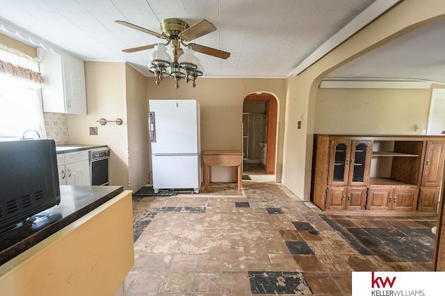 90 N Montgomery St, Nelson, NE 68961 - kitchen featuring freestanding refrigerator, a ceiling fan, arched walkways, white cabinets, and black microwave