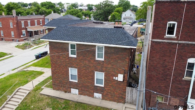 818 S 26th St, Omaha, NE 68105 - view of property exterior featuring brick siding and roof with shingles