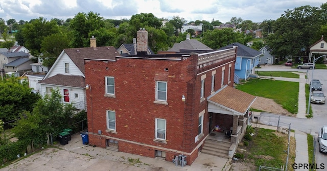 2609 Marcy St, Omaha, NE 68105 - rear view of property with brick siding and a chimney