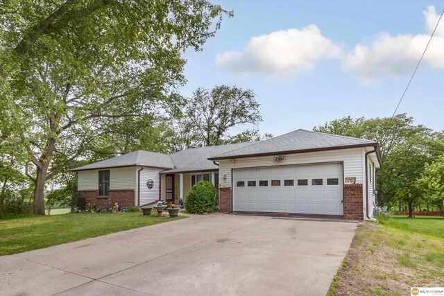 209 Carter St, Avoca, NE 68307 - single story home featuring brick siding, concrete driveway, a garage, and a front yard