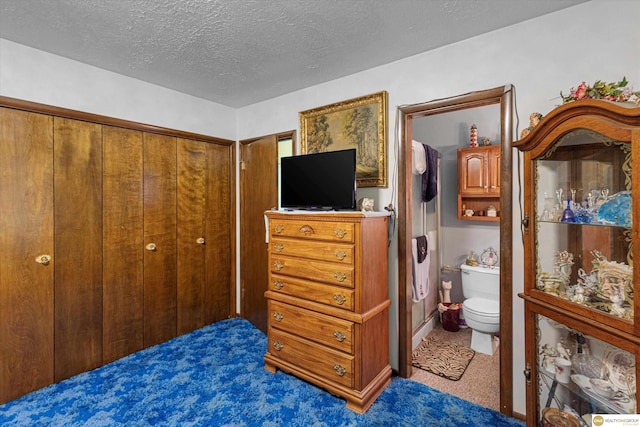 209 Carter St, Avoca, NE 68307 - carpeted bedroom featuring a textured ceiling, ensuite bath, and a closet