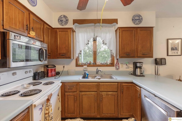 209 Carter St, Avoca, NE 68307 - kitchen with stainless steel appliances, ceiling fan, light countertops, and brown cabinets