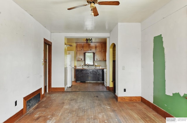 1822 N 38th St, Omaha, NE 68111 - unfurnished living room with dark wood-style floors, a ceiling fan, arched walkways, and baseboards