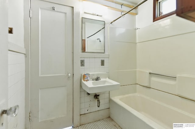 1822 N 38th St, Omaha, NE 68111 - bathroom with tile patterned flooring, shower / bathtub combination, a sink, and tile walls