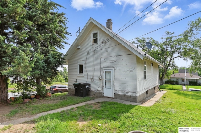 1822 N 38th St, Omaha, NE 68111 - rear view of property with a chimney and a lawn