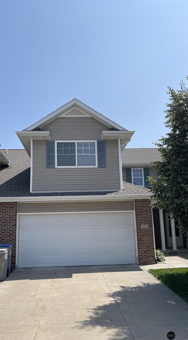 6028 Glenbrook Ln, Lincoln, NE 68512 - view of front of property with brick siding, driveway, and a garage