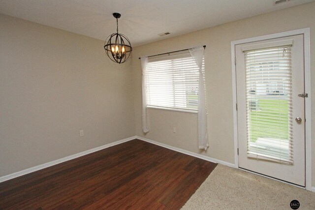 6028 Glenbrook Ln, Lincoln, NE 68512 - unfurnished dining area featuring a chandelier, wood finished floors, and baseboards