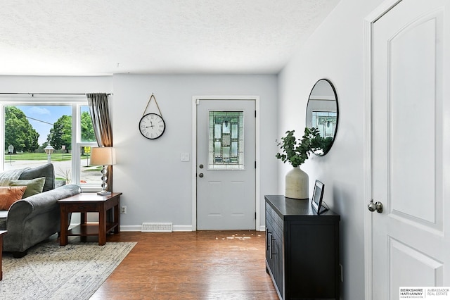 9704 Erskine St, Omaha, NE 68134 - foyer featuring wood finished floors and a textured ceiling