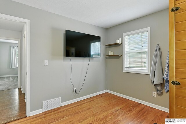 9704 Erskine St, Omaha, NE 68134 - unfurnished living room with wood finished floors and baseboards