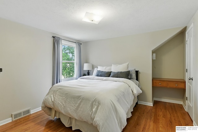 9704 Erskine St, Omaha, NE 68134 - bedroom with wood finished floors and a textured ceiling