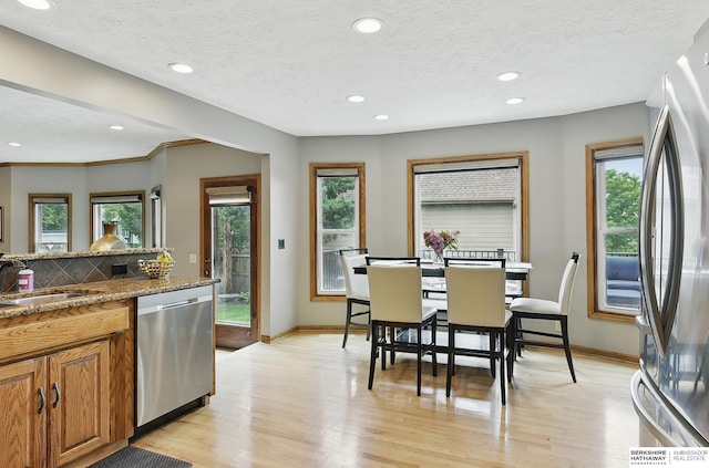 2468 N 148th St, Omaha, NE 68116 - kitchen featuring appliances with stainless steel finishes, a sink, baseboards, healthy amount of natural light, and recessed lighting