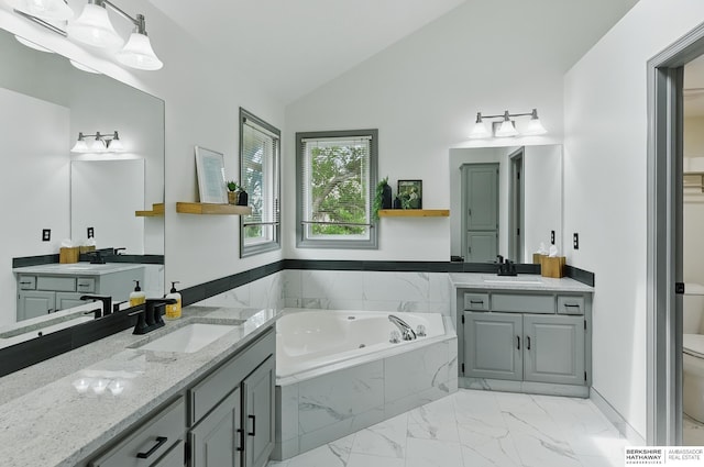 2468 N 148th St, Omaha, NE 68116 - bathroom featuring marble finish floors, a garden tub, two vanities, vaulted ceiling, and toilet