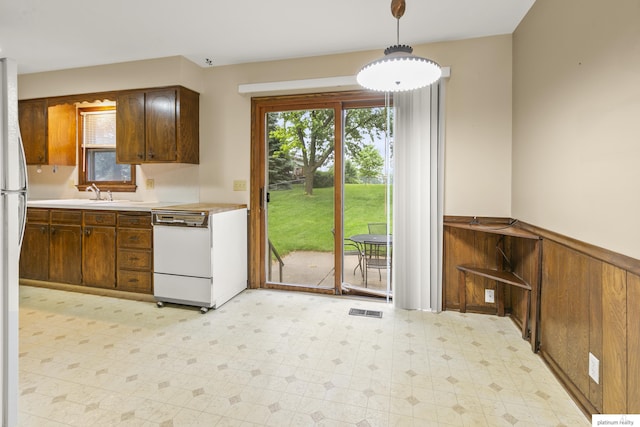 3809 N 94th St, Omaha, NE 68134 - kitchen featuring white dishwasher, light floors, light countertops, and plenty of natural light