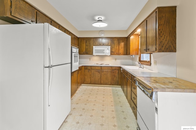 3809 N 94th St, Omaha, NE 68134 - kitchen with white appliances, light floors, a sink, light countertops, and brown cabinets